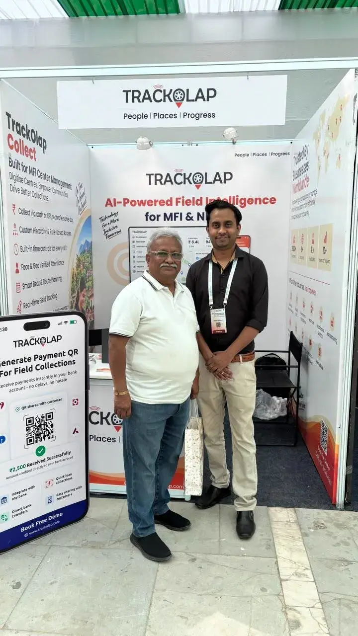 TrackOlap representative and visitor at the Sa-Dhan 2026 booth